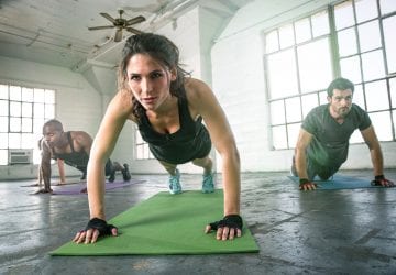 Woman leading a group through a HIIT workout