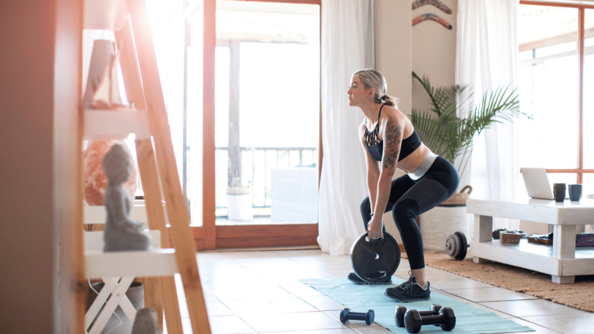a woman exercising at home in her home gym
