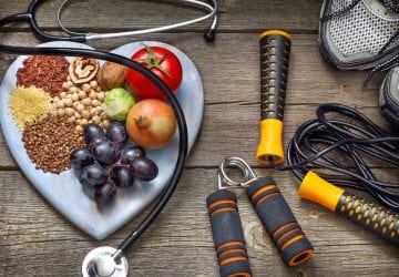 healthy food and exercise equipment on a table