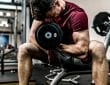 man doing arm curls with dumbell