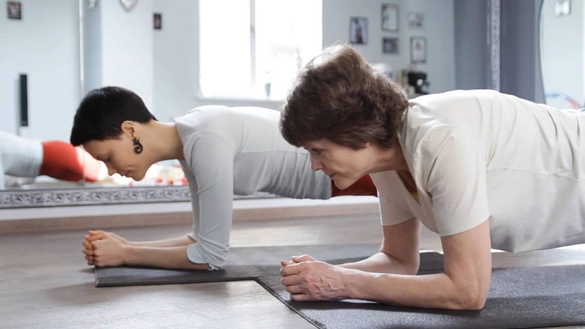 a couple doing planks at home