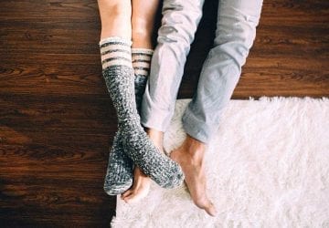 legs of a couple who are lying on the floor