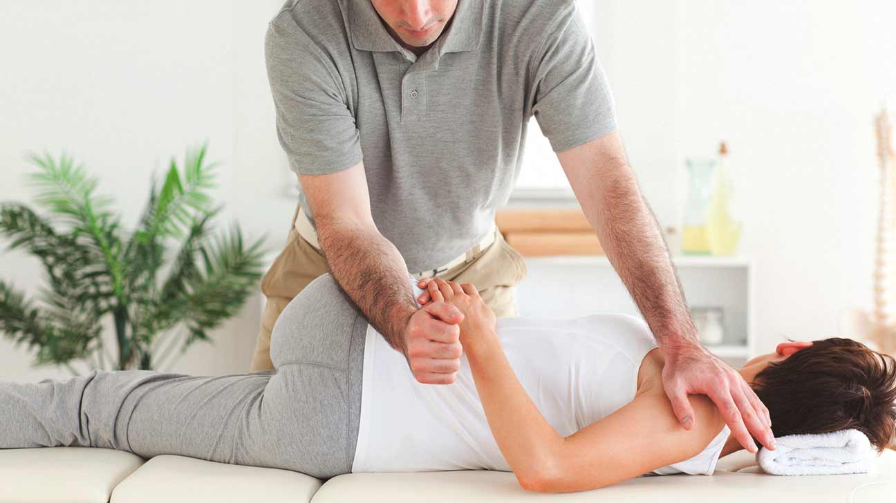 chiropractor aligning a womans spine
