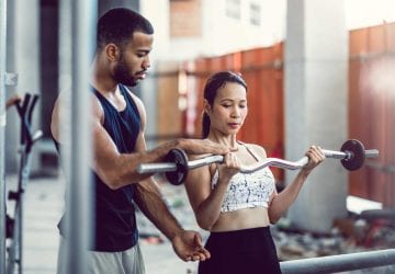 woman getting help by a personal trainer