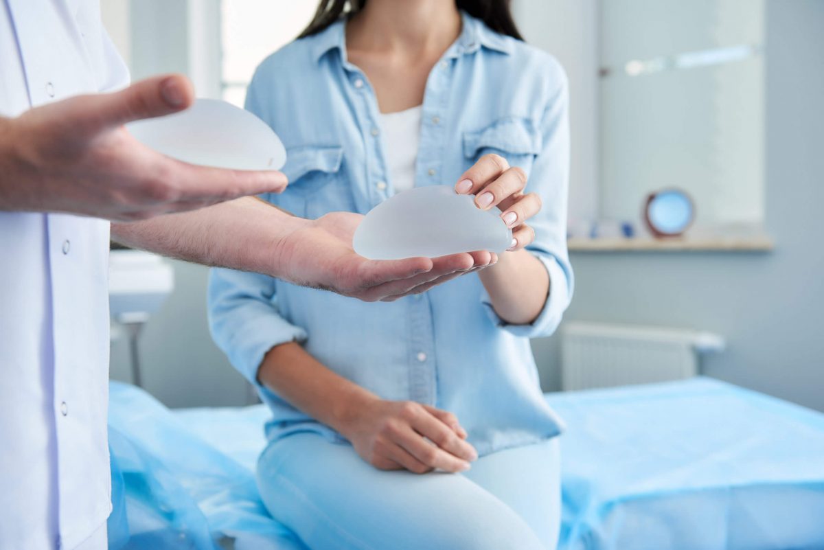 a patient being shown different breast implants
