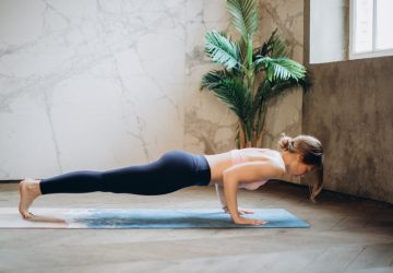 a woman doing a plank indoors