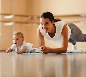 a woman working out with her baby