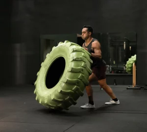 a man flipping a tire in the gym