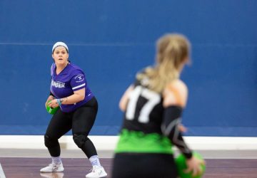 a woman getting ready to throw a dodgeball