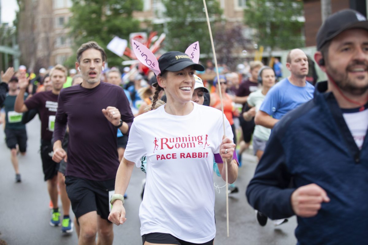 a woman leading a group of runners