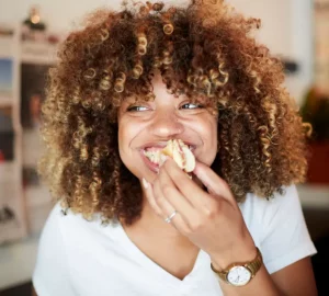 a woman eating and smiling