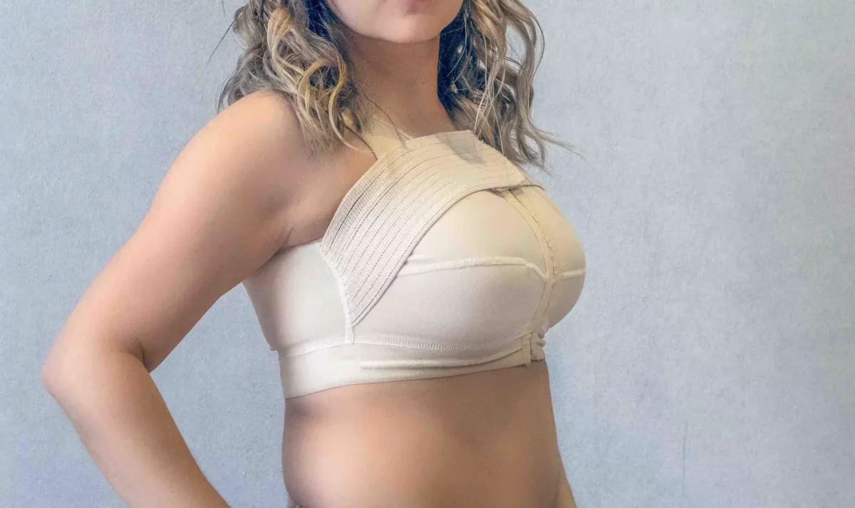 a woman after breast augmentation surgery