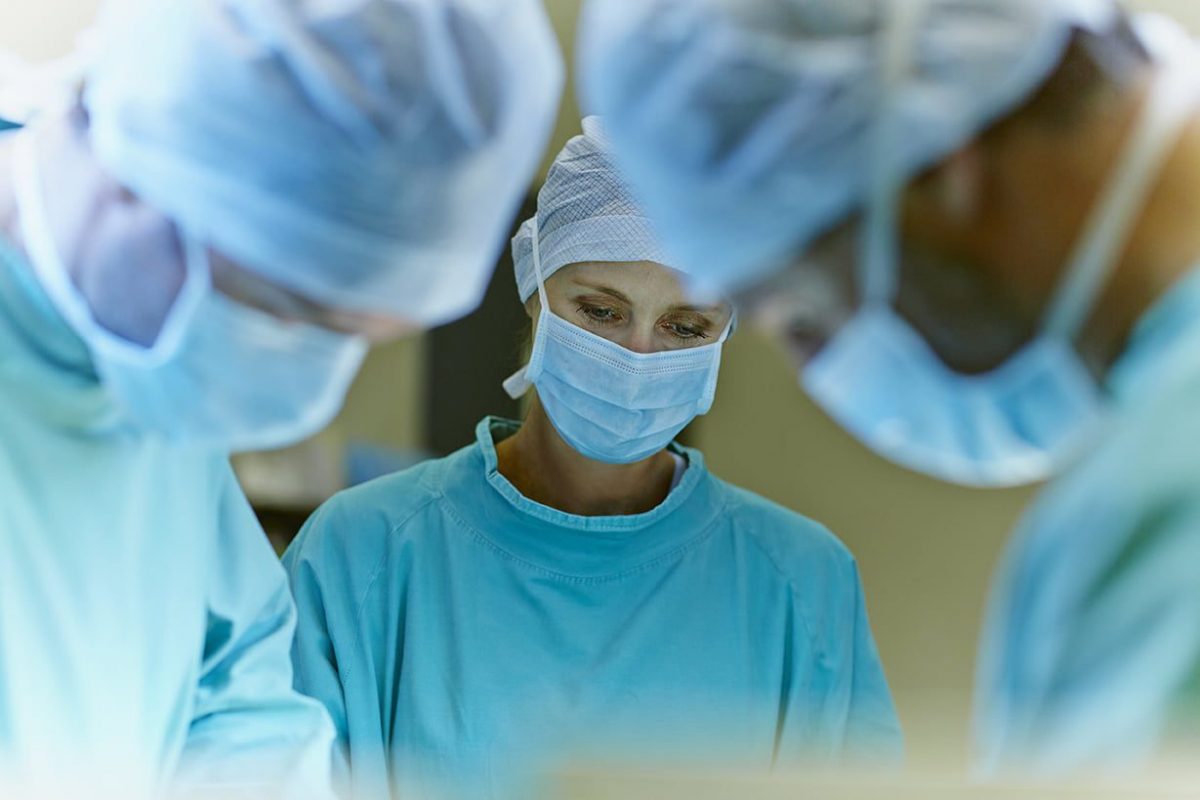 a group of surgeons in an operating room