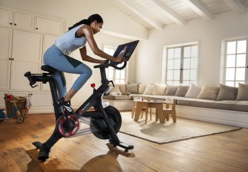 a woman doing spin in her living room
