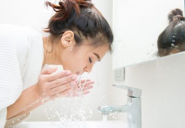 a woman washing her face