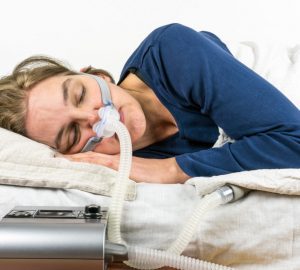 a woman with a sleep apnea machine