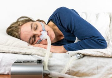 a woman with a sleep apnea machine