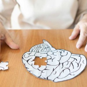 a person working on a puzzle of the brain