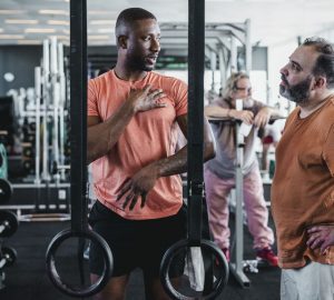 a trainer talking to a client in the gym