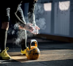 a man getting ready to use a kettlebell