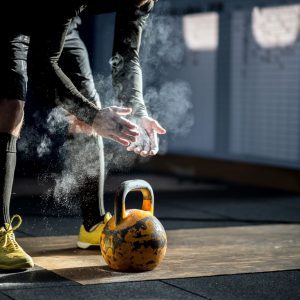 a man getting ready to use a kettlebell