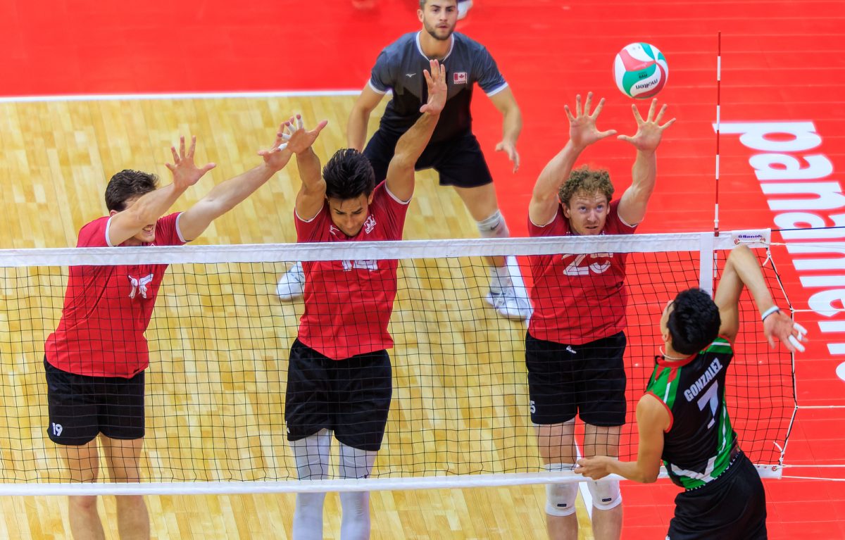 a group of volleyball players at the net