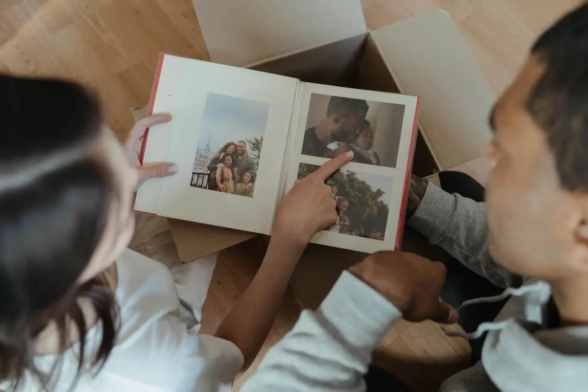 a parent and child looking at a photo album