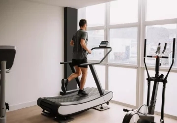 a man running using a manual treadmill