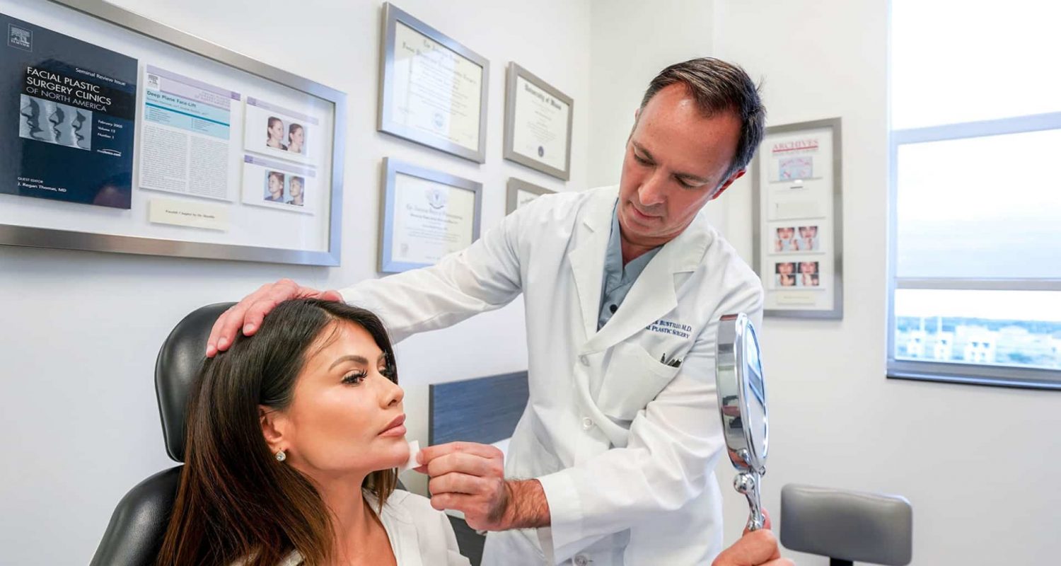 a woman being looked at by a cosmetic surgeon
