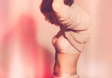 a young woman in a pink bra