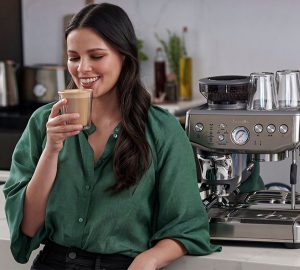 a woman enjoying a coffee beverage